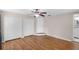 Bedroom with hardwood floors, ceiling fan, closets, and bathroom access at 864 Naples Dr, Orlando, FL 32804