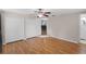 Bedroom with hardwood floors, a ceiling fan, and a bathroom at 864 Naples Dr, Orlando, FL 32804