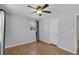 This is a bedroom with hardwood floors, a ceiling fan, and a window at 864 Naples Dr, Orlando, FL 32804