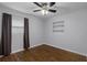 Bedroom featuring hardwood floors, a window with dark curtains, a built-in shelving unit and neutral gray walls at 864 Naples Dr, Orlando, FL 32804