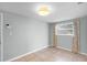 This cozy bedroom features a ceiling light and fan, light blue walls, neutral curtains, and tile flooring at 864 Naples Dr, Orlando, FL 32804