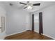 Bedroom with hardwood floors, a window with curtains, and a ceiling fan with lighting at 864 Naples Dr, Orlando, FL 32804