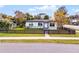 This single-story home boasts a well-maintained lawn, black picket fence, and lovely curb appeal at 864 Naples Dr, Orlando, FL 32804
