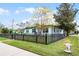 Charming single-story home boasts a well-maintained lawn and black picket fence on a corner lot at 864 Naples Dr, Orlando, FL 32804