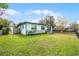 Charming single story home with a well-manicured lawn, decorative shutters, and fenced yard at 864 Naples Dr, Orlando, FL 32804