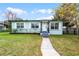 Charming single-story home boasts a well-maintained lawn, inviting front porch and walkway at 864 Naples Dr, Orlando, FL 32804