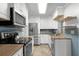 Modern kitchen boasting stainless steel appliances, white cabinets, and a stylish blue backsplash at 864 Naples Dr, Orlando, FL 32804