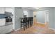 Stylish kitchen featuring white cabinets, stainless steel appliances, and a breakfast bar with seating at 864 Naples Dr, Orlando, FL 32804
