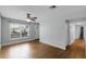 Bright living room featuring hardwood floors, ceiling fan, and large window letting in plenty of natural light at 864 Naples Dr, Orlando, FL 32804