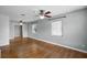 Spacious living room featuring hardwood floors, neutral walls, ceiling fan, and bright windows at 864 Naples Dr, Orlando, FL 32804
