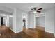 Open-concept living space showcasing hardwood floors and entryways to the kitchen and an additional room at 864 Naples Dr, Orlando, FL 32804