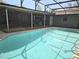 Backyard view of large, in-ground pool and patio at 876 Lobster Ct, Kissimmee, FL 34744