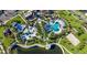 Aerial view of community pools, playgrounds, recreation areas, and lush landscaping, offering resort-style living at 8914 Caroline Bay Ct, Kissimmee, FL 34747