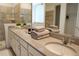 Elegant bathroom featuring dual sinks, a quartz countertop, and a tiled walk-in shower at 8914 Caroline Bay Ct, Kissimmee, FL 34747