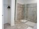Spacious bathroom with tiled floors, a glass shower enclosure, and closet storage at 8914 Caroline Bay Ct, Kissimmee, FL 34747