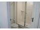 Bathroom featuring all white fixtures, including a stand up shower at 8914 Caroline Bay Ct, Kissimmee, FL 34747