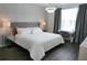 Stylish bedroom features a large bed, modern lighting, a desk, and a patterned wall at 8914 Caroline Bay Ct, Kissimmee, FL 34747