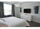 Inviting bedroom features a sleek white dresser and a well-lit desk area at 8914 Caroline Bay Ct, Kissimmee, FL 34747