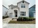 Charming two-story home features a well-manicured front yard with a stone-paved driveway at 8914 Caroline Bay Ct, Kissimmee, FL 34747