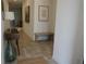 Inviting hallway with stylish tile flooring, contemporary decor, and bench seating, creating a welcoming entrance at 8914 Caroline Bay Ct, Kissimmee, FL 34747