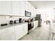 A bright kitchen features white cabinets, stainless appliances, and quartz countertops at 8914 Caroline Bay Ct, Kissimmee, FL 34747