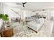 Bright living room featuring modern decor, tile floors, and an open layout to the kitchen at 8914 Caroline Bay Ct, Kissimmee, FL 34747