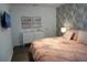 Comfortable main bedroom with a plush bed, patterned wallpaper, and soft pink bedding at 8914 Caroline Bay Ct, Kissimmee, FL 34747