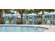 Relaxing pool area with private cabanas, lounge chairs, and palm trees, offering a tranquil escape at 8914 Caroline Bay Ct, Kissimmee, FL 34747