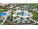 Aerial view of splash pad featuring colorful water features, cabanas, and lush greenery at 8914 Caroline Bay Ct, Kissimmee, FL 34747