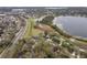 An aerial view showcasing a community with lake views along a highway at 892 Cool Springs Cir, Ocoee, FL 34761