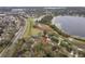 An aerial view showcasing a community with lake views along a highway at 892 Cool Springs Cir, Ocoee, FL 34761