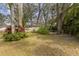 The backyard features mature trees and green space providing a tranquil setting for outdoor activities and relaxation at 892 Cool Springs Cir, Ocoee, FL 34761