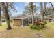 The backyard features a screened lanai, mature trees, and vibrant landscaping, offering privacy and natural beauty at 892 Cool Springs Cir, Ocoee, FL 34761