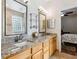 Bright bathroom with granite countertops, double sinks, and a walk-in shower at 892 Cool Springs Cir, Ocoee, FL 34761