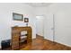 Bedroom featuring a desk, wood flooring, and an open doorway at 892 Cool Springs Cir, Ocoee, FL 34761