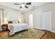 Comfortable bedroom with a ceiling fan, closet, and wood flooring at 892 Cool Springs Cir, Ocoee, FL 34761
