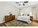 Inviting bedroom with hardwood floors, decorative rug, and neutral color scheme at 892 Cool Springs Cir, Ocoee, FL 34761