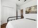 Well-lit bedroom showcasing hardwood floors, double door closet, an open door and modern art at 892 Cool Springs Cir, Ocoee, FL 34761