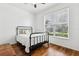 Bright bedroom with hardwood floors, ceiling fan, and a large window letting in plenty of natural light at 892 Cool Springs Cir, Ocoee, FL 34761