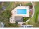 Aerial view of a community pool, featuring lounge chairs, umbrellas, and manicured landscaping for outdoor relaxation and recreation at 892 Cool Springs Cir, Ocoee, FL 34761