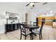 Cozy dining area featuring a round table, adjacent kitchen, and elegant black accents at 892 Cool Springs Cir, Ocoee, FL 34761