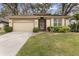 Charming single-story home with a well-manicured lawn, neutral-colored exterior, and attached garage at 892 Cool Springs Cir, Ocoee, FL 34761