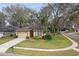 Charming single-story home featuring a two-car garage, well-manicured lawn, and beautiful landscaping for enhanced curb appeal at 892 Cool Springs Cir, Ocoee, FL 34761