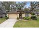 Charming single-story home featuring a two-car garage, well-manicured lawn, and beautiful landscaping for enhanced curb appeal at 892 Cool Springs Cir, Ocoee, FL 34761