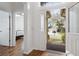 Bright foyer with wood floors, bedroom view, and a glimpse of the home's exterior at 892 Cool Springs Cir, Ocoee, FL 34761