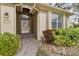 Inviting front entrance with brick walkway, landscaped garden, and decorative architectural details at 892 Cool Springs Cir, Ocoee, FL 34761