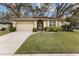 Charming single-story home with a well-manicured lawn, neutral-colored exterior, and attached garage at 892 Cool Springs Cir, Ocoee, FL 34761