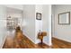 Hallway with wood floors and white walls offering a view into the living room at 892 Cool Springs Cir, Ocoee, FL 34761