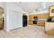 Open kitchen with stainless steel appliances, wood cabinets, and tile flooring at 892 Cool Springs Cir, Ocoee, FL 34761