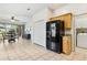 Kitchen with stainless steel refrigerator and access to a laundry room at 892 Cool Springs Cir, Ocoee, FL 34761